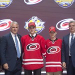 Jake Bean stands on stage with members of the Carolina Hurricanes management team at the NHL hockey draft, Friday, June 24, 2016, in Buffalo, N.Y. (Nathan Denette/The Canadian Press via AP)