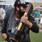 Coastal Carolina's Anthony Marks kisses the championship trophy after beating Arizona 4-3 in Game 3 of the NCAA College World Series baseball finals in Omaha, Neb., Thursday, June 30, 2016. (AP Photo/Ted Kirk)