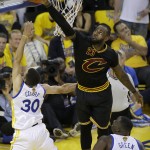 Cleveland Cavaliers forward LeBron James, top, blocks a shot by Golden State Warriors guard Stephen Curry (30) during the first half of Game 7 of basketball's NBA Finals in Oakland, Calif., Sunday, June 19, 2016. (AP Photo/Eric Risberg)