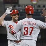 Philadelphia Phillies' Peter Bourjos, left, smiles as he celebrates his two-run home run against the Arizona Diamondbacks with Odubel Herrera (37) during the first inning of a baseball game Wednesday, June 29, 2016, in Phoenix. (AP Photo/Ross D. Franklin)