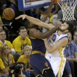 Golden State Warriors center Andrew Bogut (12) blocks a shot by Cleveland Cavaliers center Tristan Thompson during the first half of Game 2 of basketball's NBA Finals in Oakland, Calif., Sunday, June 5, 2016. (AP Photo/Marcio Jose Sanchez)