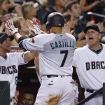 Arizona Diamondbacks' Welington Castillo (7) celebrates his run scored against the Miami Marlins with manager Chip Hale (3) and David Peralta, left, during the fifth inning of a baseball game Friday, June 10, 2016, in Phoenix. (AP Photo/Ross D. Franklin)