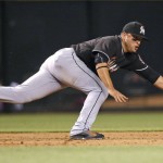 Miami Marlins' Martin Prado dives in vain for a grounder hit by Arizona Diamondbacks' Yasmany Tomas during the fifth inning of a baseball game Friday, June 10, 2016, in Phoenix. (AP Photo/Ross D. Franklin)
