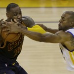 Golden State Warriors forward Andre Iguodala, right, reaches for the ball against Cleveland Cavaliers forward LeBron James during the first half of Game 1 of basketball's NBA Finals in Oakland, Calif., Thursday, June 2, 2016. (AP Photo/Ben Margot)