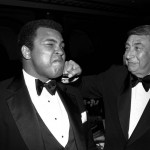 FILE - In this April 13, 1981, file photo, sportscaster Howard Cosell, right, is pictured laying one on the chin of former world heavyweight boxing champ Muhammad Ali during a dinner in New York. Ali, the magnificent heavyweight champion whose fast fists and irrepressible personality transcended sports and captivated the world, has died according to a statement released by his family Friday, June 3, 2016. He was 74. (AP Photo/Richard Drew, File)