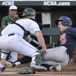 Arizona's Kyle Lewis, right, is tagged out at home plate by Miami catcher Zack Collins after a two-run single by Arizona's Jared Oliva in the first inning of an NCAA men's College World Series baseball game in Omaha, Neb., Saturday, June 18, 2016. (AP Photo/Mike Theiler)