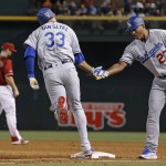 Los Angeles Dodgers' Scott Van Slyke (33) shakes hands with first base coach George Lombard (27) as Van Slyke rounds the bases after hitting a three-run home run as Arizona Diamondbacks' Paul Goldschmidt (44) walks away from the action during the sixth inning of a baseball game Wednesday, June 15, 2016, in Phoenix. (AP Photo/Ross D. Franklin)