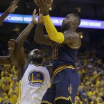 Cleveland Cavaliers forward LeBron James (23) shoots against Golden State Warriors center Festus Ezeli (31) during the second half of Game 1 of basketball's NBA Finals in Oakland, Calif., Thursday, June 2, 2016. (AP Photo/Marcio Jose Sanchez)