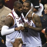 Cleveland Cavaliers forward LeBron James (23) and Cleveland Cavaliers guard J.R. Smith (5) celebrate after beating the Golden State Warriors 115-101 in Game 6 of basketball's NBA Finals in Cleveland, Thursday, June 16, 2016.  (AP Photo/Ron Schwane)