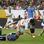 Mexico's Hector Herrera (16) collides with Uruguay's Alvaro Pereira (6) after Herrera sends the ball in for a goal as Mexico's Javier Hernandez (14) celebrates and Uruguay's Diego Godin (3) looks on during the first half of a Copa America soccer match at University of Phoenix Stadium, Sunday, June 5, 2016, in Glendale, Ariz. (AP Photo/Ross D. Franklin)