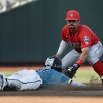 Arizona shortstop Louis Boyd (5) tags Coastal Carolina's Billy Cooke out attempting to steal second base in the third inning in Game 1 of the NCAA Men's College World Series finals baseball game in Omaha, Neb., Monday, June 27, 2016. (AP Photo/Ted Kirk)