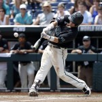 Coastal Carolina's G.K. Young hits a two-run home run against Arizona pitcher Bobby Dalbec in the sixth inning in Game 3 of the NCAA College World Series baseball finals in Omaha, Neb., Thursday, June 30, 2016. (AP Photo/Nati Harnik)