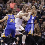 Cleveland Cavaliers forward Kevin Love, center drives on Golden State Warriors guard Stephen Curry (30) and Shaun Livingston during the first half of Game 6 of basketball's NBA Finals in Cleveland, Thursday, June 16, 2016. (AP Photo/Tony Dejak)