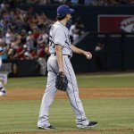 Tampa Bay Rays' Matt Moore, middle, walks back to the mound with a new baseball after giving up a three-run home run to Arizona Diamondbacks' Jake Lamb, left, as Rays' Taylor Motter, right, waits during the fourth inning of a baseball game Tuesday, June 7, 2016, in Phoenix. (AP Photo/Ross D. Franklin)