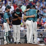 Coastal Carolina pitcher Zack Hopeck (2) is hugged by relief pitcher Cole Schaefer during a pitching change as catcher David Parrett (12) and pitching coach Drew Thomas wait against Arizona in the seventh inning in Game 1 of the NCAA Men's College World Series finals baseball game in Omaha, Neb., Monday, June 27, 2016. (AP Photo/Ted Kirk)