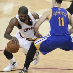 Cleveland Cavaliers guard Kyrie Irving (2) drives on Golden State Warriors guard Klay Thompson (11) during the first half of Game 6 of basketball's NBA Finals in Cleveland, Thursday, June 16, 2016. (AP Photo/Ron Schwane)