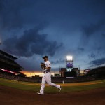 In this view through a fisheye lens, Colorado Rockies right fielder Ryan Raburn heads back to the dugout after the top of the fifth inning of a baseball game against the Arizona Diamondbacks on Friday, June 24, 2016, in Denver. (AP Photo/David Zalubowski)
