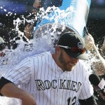 Colorado Rockies' Mark Reynolds, front, is doused by relief pitchers Jason Motte, back left, and Justin Miller after hitting a walkoff two-run home run off Arizona Diamondbacks relief pitcher Silvino Bracho in the ninth inning of a baseball game Sunday, June 26, 2016, in Denver.  (AP Photo/David Zalubowski)