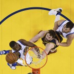 Golden State Warriors forward Harrison Barnes, left, shoots against Cleveland Cavaliers forward Kevin Love, center, during the first half of Game 2 of basketball's NBA Finals in Oakland, Calif., Thursday, June 2, 2016. (John G, Mabanglo, European Pressphoto Agency via AP, Pool)