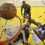Golden State Warriors forward Draymond Green (23) shoots over Cleveland Cavaliers forward Kevin Love, center, during the first half of Game 2 of basketball's NBA Finals in Oakland, Calif., Thursday, June 2, 2016. (Ezra Shaw, Getty Images via AP, Pool)