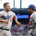 Los Angeles Dodgers' Corey Seager (5) slaps hands with Adrian Gonzalez (23) after Seager scored a run against the Arizona Diamondbacks during the first inning of a baseball game Monday, June 13, 2016, in Phoenix. (AP Photo/Ross D. Franklin)