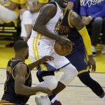 Golden State Warriors forward Draymond Green, center, shoots against the Cleveland Cavaliers during the first half of Game 1 of basketball's NBA Finals in Oakland, Calif., Thursday, June 2, 2016. (AP Photo/Marcio Jose Sanchez)