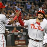 Philadelphia Phillies' Freddy Galvis, right, smiles as he celebrates with Maikel Franco (7) after both scored runs against the Arizona Diamondbacks during the seventh inning of a baseball game Monday, June 27, 2016, in Phoenix. (AP Photo/Ross D. Franklin)