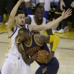 Cleveland Cavaliers forward LeBron James, bottom, is defended by Golden State Warriors guard Klay Thompson during the second half of Game 1 of basketball's NBA Finals in Oakland, Calif., Thursday, June 2, 2016. (AP Photo/Ben Margot)