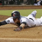 Arizona Diamondbacks' Nick Ahmed slides past home plate after scoring against the Miami Marlins on a single by Jean Segura during the fourth inning of a baseball game Friday, June 10, 2016, in Phoenix. (AP Photo/Ross D. Franklin)