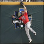 Arizona right fielder Zach Gibbons catches a Coastal Carolina Michael Paez (1) fly ball in the eighth inning in Game 1 of the NCAA Men's College World Series finals baseball game in Omaha, Neb., Monday, June 27, 2016. (AP Photo/Nati Harnik)
