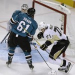 Pittsburgh Penguins' Evgeni Malkin, right, celebrates after scoring a goal against San Jose Sharks goalie Martin Jones and Justin Braun (61) during the second period of Game 4 of the NHL hockey Stanley Cup Finals on Monday, June 6, 2016, in San Jose, Calif. (AP Photo/Eric Risberg)