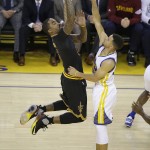 Cleveland Cavaliers guard J.R. Smith, left, shoots against Golden State Warriors guard Stephen Curry during the first half of Game 7 of basketball's NBA Finals in Oakland, Calif., Sunday, June 19, 2016. (AP Photo/Eric Risberg)