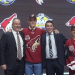 Jakob Chychrun stands on stage with members of the Arizona Coyotes management team at the NHL hockey draft, Friday, June 24, 2016, in Buffalo, N.Y. (Nathan Denette/The Canadian Press via AP)