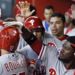 Philadelphia Phillies' Odubel Herrera, second from right, slaps the helmet of Peter Bourjos (17) after Bourjos scored against the Arizona Diamondbacks during the 10th inning of a baseball game Wednesday, June 29, 2016, in Phoenix. The Phillies defeated the Diamondbacks 9-8. (AP Photo/Ross D. Franklin)