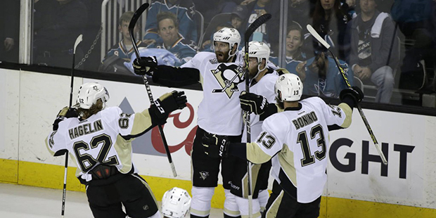 Pittsburgh Penguins right wing Eric Fehr, second from left, is greeted by his teammates after scori...