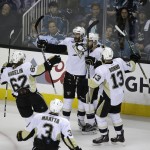 Pittsburgh Penguins right wing Eric Fehr, second from left, is greeted by his teammates after scoring a goal against the San Jose Sharks during the third period of Game 4 of the NHL hockey Stanley Cup Finals in San Jose, Calif., Monday, June 6, 2016. Pittsburgh won the game 3-1. (AP Photo/Eric Risberg)