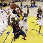 Cleveland Cavaliers' LeBron James (23) battles for a rebound against Golden State Warriors' Leandro Barbosa (19) and Draymond Green (23) during the first half in Game 1 of basketball's NBA Finals Thursday, June 2, 2016, in Oakland, Calif. (AP Photo/Marcio Jose Sanchez, Pool)