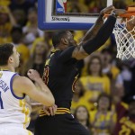 Cleveland Cavaliers forward LeBron James, right, dunks in front of Golden State Warriors guard Klay Thompson (11) during the first half of Game 7 of basketball's NBA Finals in Oakland, Calif., Sunday, June 19, 2016. (AP Photo/Marcio Jose Sanchez)