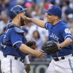 Toronto Blue Jays catcher Martin Russell embraces pitcher Roberto Osuna after the Blue Jays defeated the Arizona Diamondbacks in a baseball game in Toronto on Wednesday June 22, 2016. (Fred Thornhill/The Canadian Press via AP)