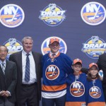Kieffer Bellows, center, stands with members of the New York Islanders management team and others at the NHL draft in Buffalo, N.Y., Friday June 24, 2016. (Nathan Denette/The Canadian Press via AP) MANDATORY CREDIT