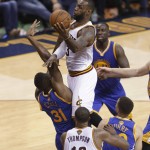 Cleveland Cavaliers forward LeBron James (23) drives against Golden State Warriors center Festus Ezeli (31) during the second half of Game 6 of basketball's NBA Finals in Cleveland, Thursday, June 16, 2016. (AP Photo/Tony Dejak)