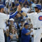 Chicago Cubs' Kris Bryant, left, celebrates with Ben Zobrist after scoring on a double hit by Addison Russell during the eighth inning of a baseball game against the Arizona Diamondbacks Friday, June 3, 2016, in Chicago. (AP Photo/Nam Y. Huh)