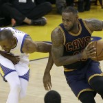 Cleveland Cavaliers forward LeBron James, right, drives against Golden State Warriors forward Andre Iguodala during the first half of Game 2 of basketball's NBA Finals in Oakland, Calif., Sunday, June 5, 2016. (AP Photo/Marcio Jose Sanchez)