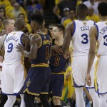 Players and officials separate Golden State Warriors forward Andre Iguodala (9) and Cleveland Cavaliers guard Matthew Dellavedova (8) during the second half of Game 1 of basketball's NBA Finals in Oakland, Calif., Thursday, June 2, 2016. (AP Photo/Marcio Jose Sanchez)