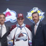 Tyson Jost, 10th overall pick, stands on stage with members of the Colorado Avalanche management team at the NHL hockey draft, Friday, June 24, 2016, in Buffalo, N.Y. (Nathan Denette/The Canadian Press via AP)