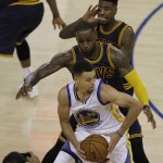 Golden State Warriors guard Stephen Curry (30) is guarded by Cleveland Cavaliers forward LeBron James, center, and guard Iman Shumpert during the second half of Game 1 of basketball's NBA Finals in Oakland, Calif., Thursday, June 2, 2016. (AP Photo/Ben Margot)