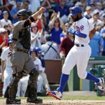 Chicago Cubs' Jason Heyward, right, scores on a double by Anthony Rizzo as Arizona Diamondbacks catcher Welington Castillo looks to the field during the sixth inning of a baseball game Friday, June 3, 2016, in Chicago. (AP Photo/Nam Y. Huh)