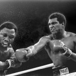 FILE - In this Oct. 1, 1975, file photo, spray flies from the head of challenger Joe Frazier as heavyweight champion Muhammad Ali connects with a right in the ninth round of their title fight in Manila, Philippines. Ali, the magnificent heavyweight champion whose fast fists and irrepressible personality transcended sports and captivated the world, has died according to a statement released by his family Friday, June 3, 2016. He was 74. (AP Photo/Mitsunori Chigita, File)