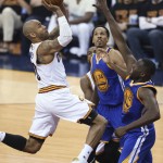 Cleveland Cavaliers guard Dahntay Jones (30) drives on Golden State Warriors guard Shaun Livingston and Draymond Green during the first half of Game 6 of basketball's NBA Finals in Cleveland, Thursday, June 16, 2016. (AP Photo/Ron Schwane)