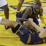 Cleveland Cavaliers forward LeBron James, top, and forward Richard Jefferson, bottom, reach for a loose ball against Golden State Warriors forward Draymond Green during the first half of Game 1 of basketball's NBA Finals in Oakland, Calif., Thursday, June 2, 2016. (AP Photo/Marcio Jose Sanchez)